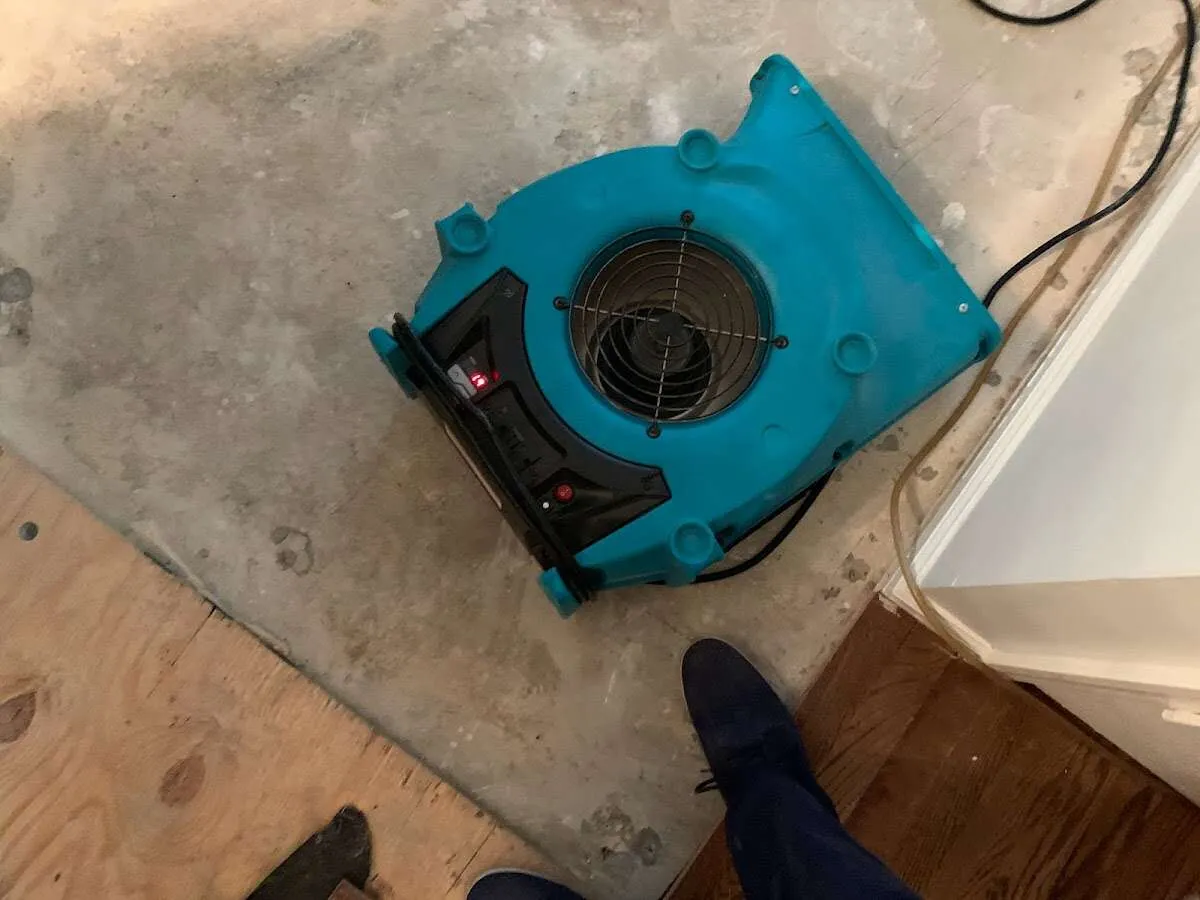 Air mover drying subfloor during Commercial Water Damage Restoration in Lake Forest